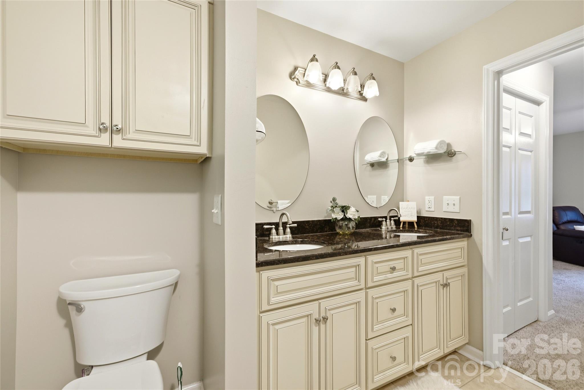 3066 Point Clear Drive Fort Mill, SC 29708 - Photo 22 of 47 a bathroom with a granite countertop toilet sink and mirror