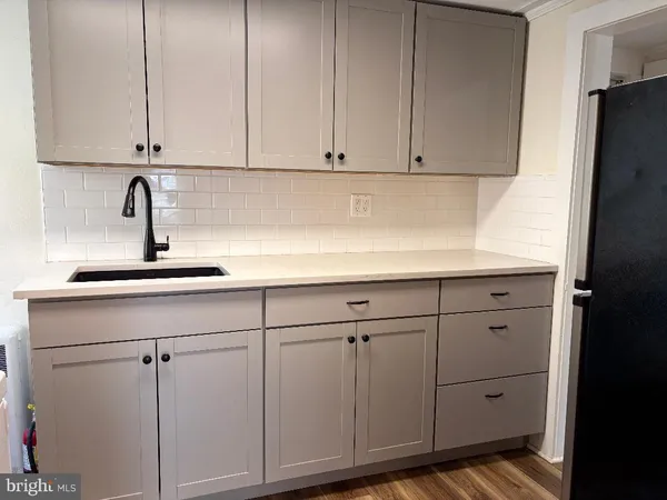 a kitchen with white cabinets and a sink