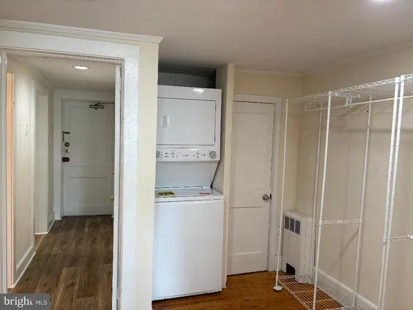 a view of a walk in closet and wooden floor
