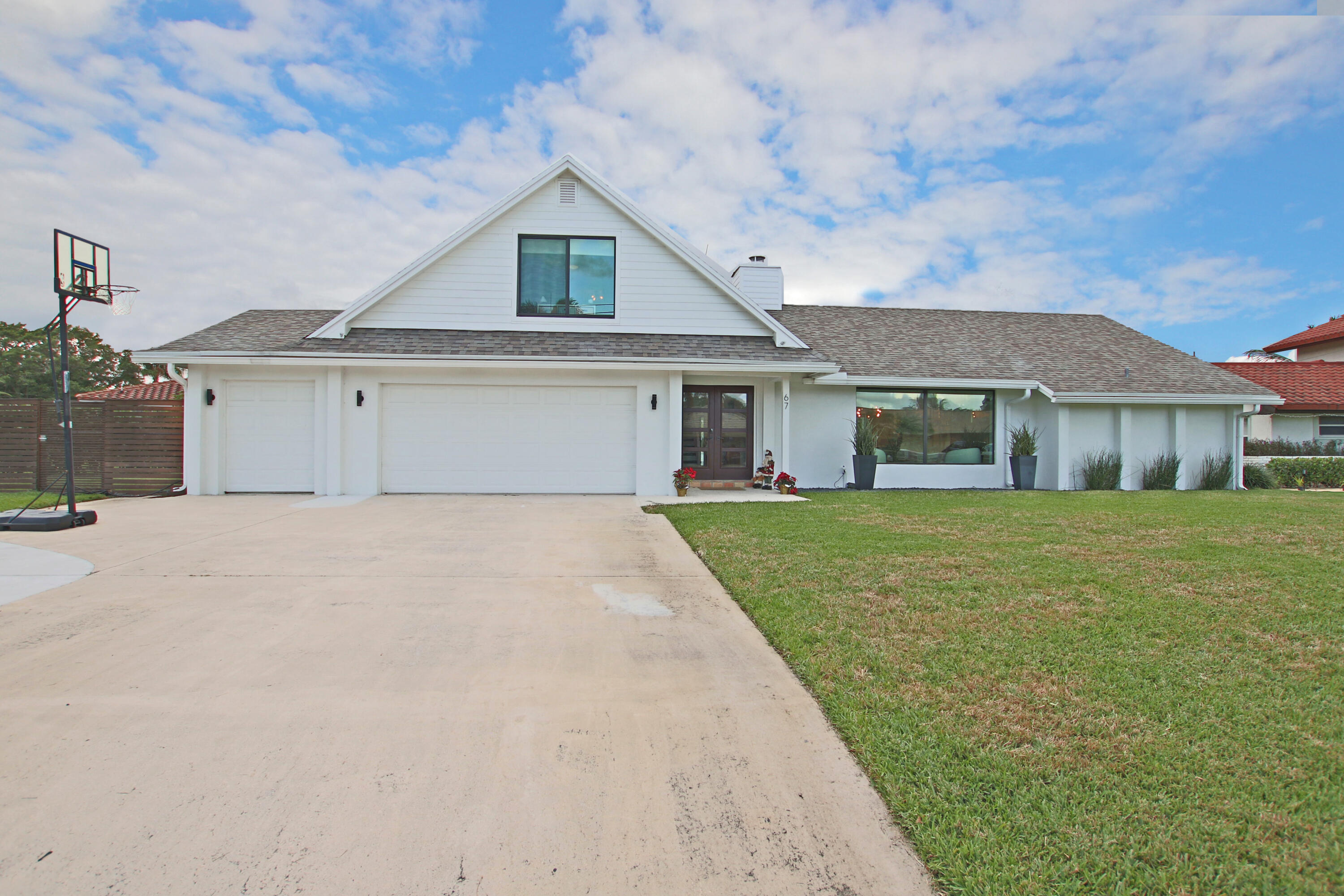 a front view of a house with a garden
