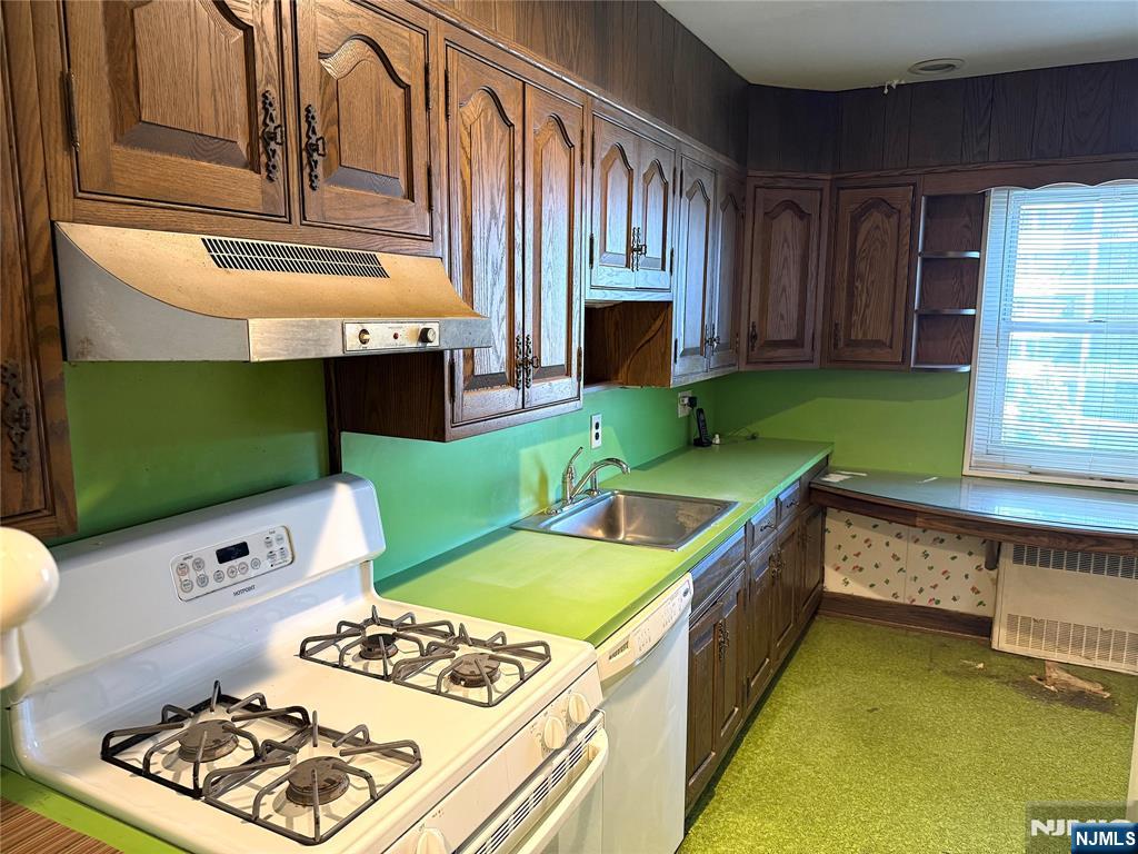 280 South Prospect Avenue, Unit 3N Hackensack, NJ 07601 - Photo 16 of 27 a kitchen with stainless steel appliances kitchen island granite countertop a stove a sink and a microwave