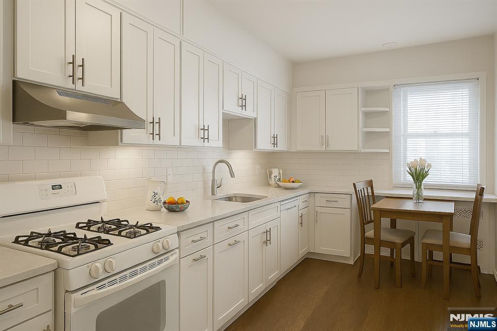 280 South Prospect Avenue, Unit 3N Hackensack, NJ 07601 - Photo 17 of 27 a kitchen with white cabinets and appliances