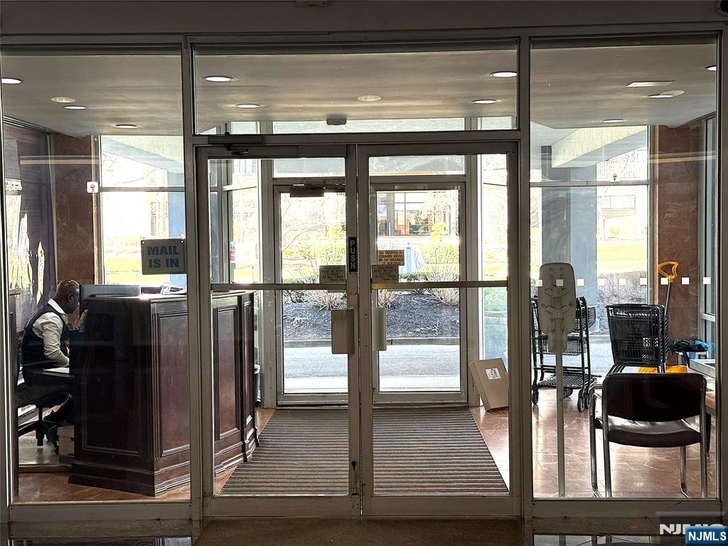 280 South Prospect Avenue, Unit 3N Hackensack, NJ 07601 - Photo 3 of 27 a view of a living room with a floor to ceiling window and kitchen view