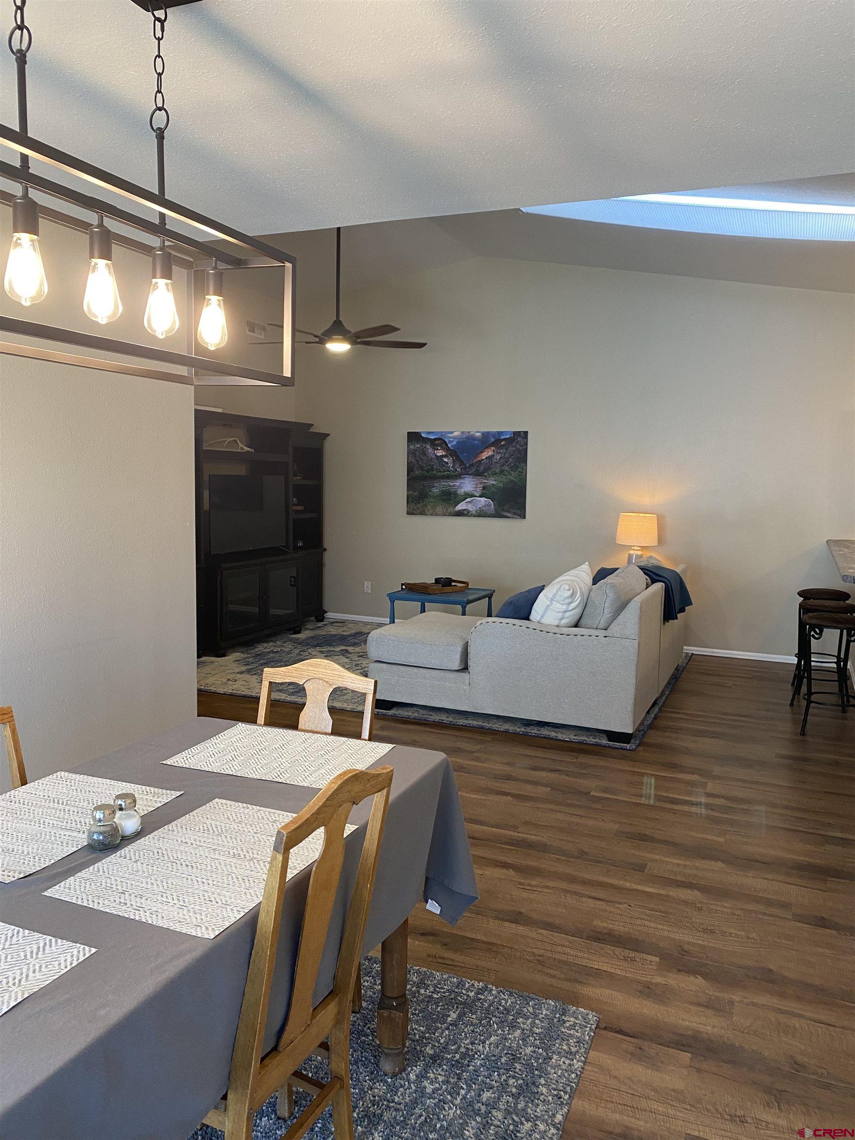 802 Riley Lane Delta, CO 81416 - Photo 4 of 16 a bedroom with furniture and a flat screen tv