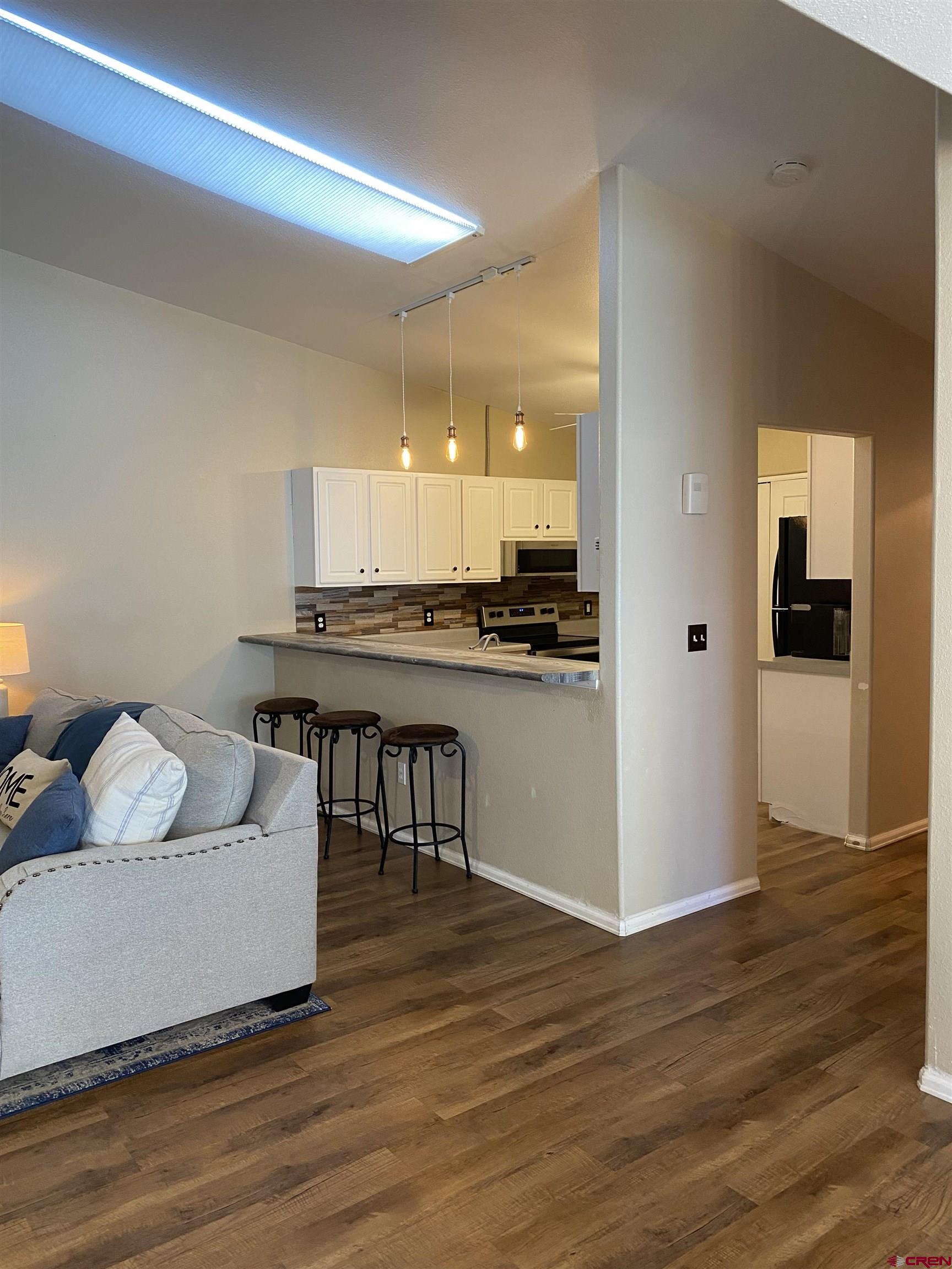 802 Riley Lane Delta, CO 81416 - Photo 5 of 16 a living room with furniture and a wooden floor