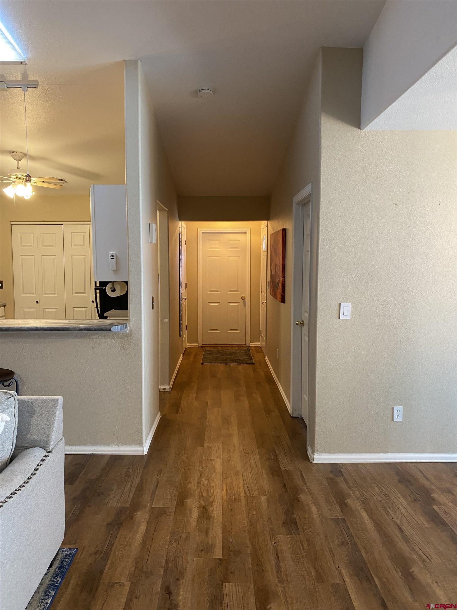 802 Riley Lane Delta, CO 81416 - Photo 6 of 16 a view of a hallway with wooden floor and furniture