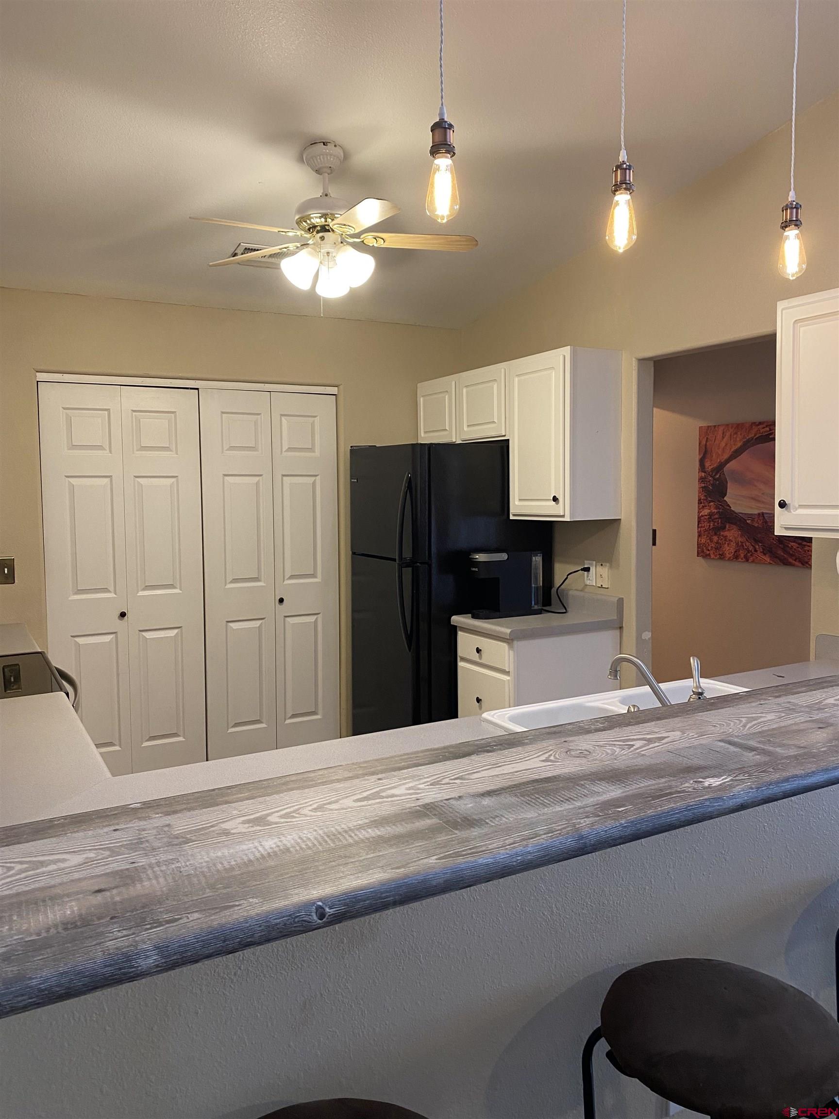 802 Riley Lane Delta, CO 81416 - Photo 9 of 16 a bedroom with a bed and a television