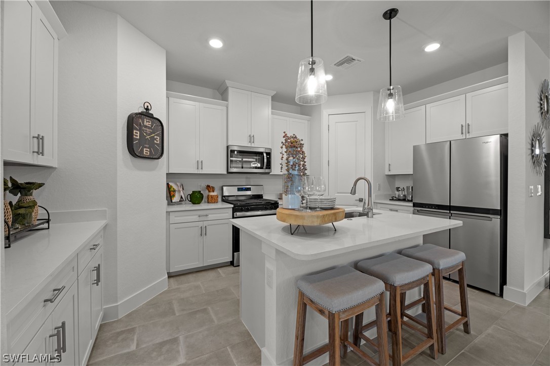 16982 Cottontail Circle Punta Gorda, FL 33982 - Photo 8 of 25 a kitchen with a refrigerator a stove a sink and chairs