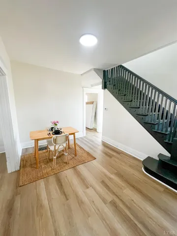 a dining room with furniture and wooden floor