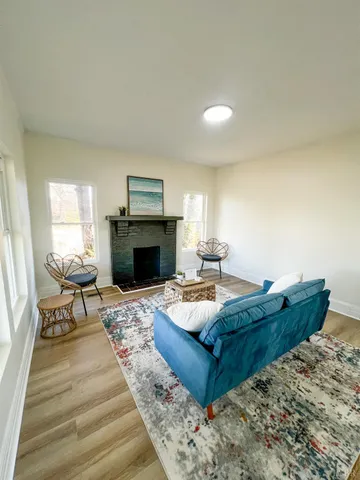 a living room with furniture and a fireplace