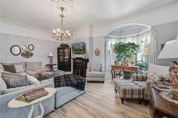 a living room with furniture and a chandelier