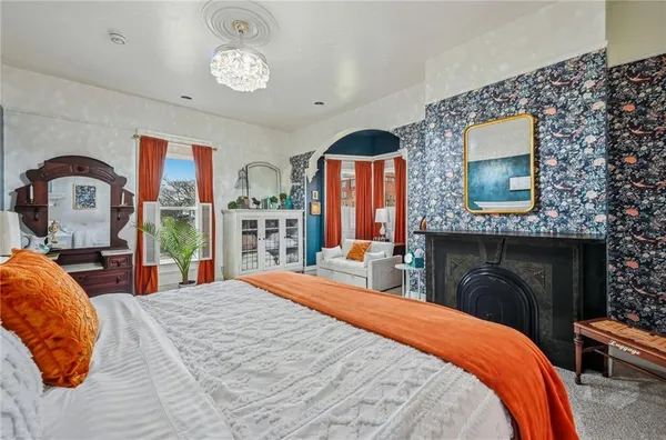 a bedroom with a bed potted plant with the mirror