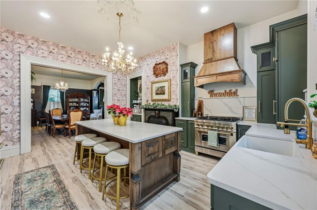 131 South Pitt Street Mercer, PA 16137 - Photo 9 of 50 a kitchen with stainless steel appliances granite countertop a stove top oven a sink dishwasher and a dining table with wooden floor