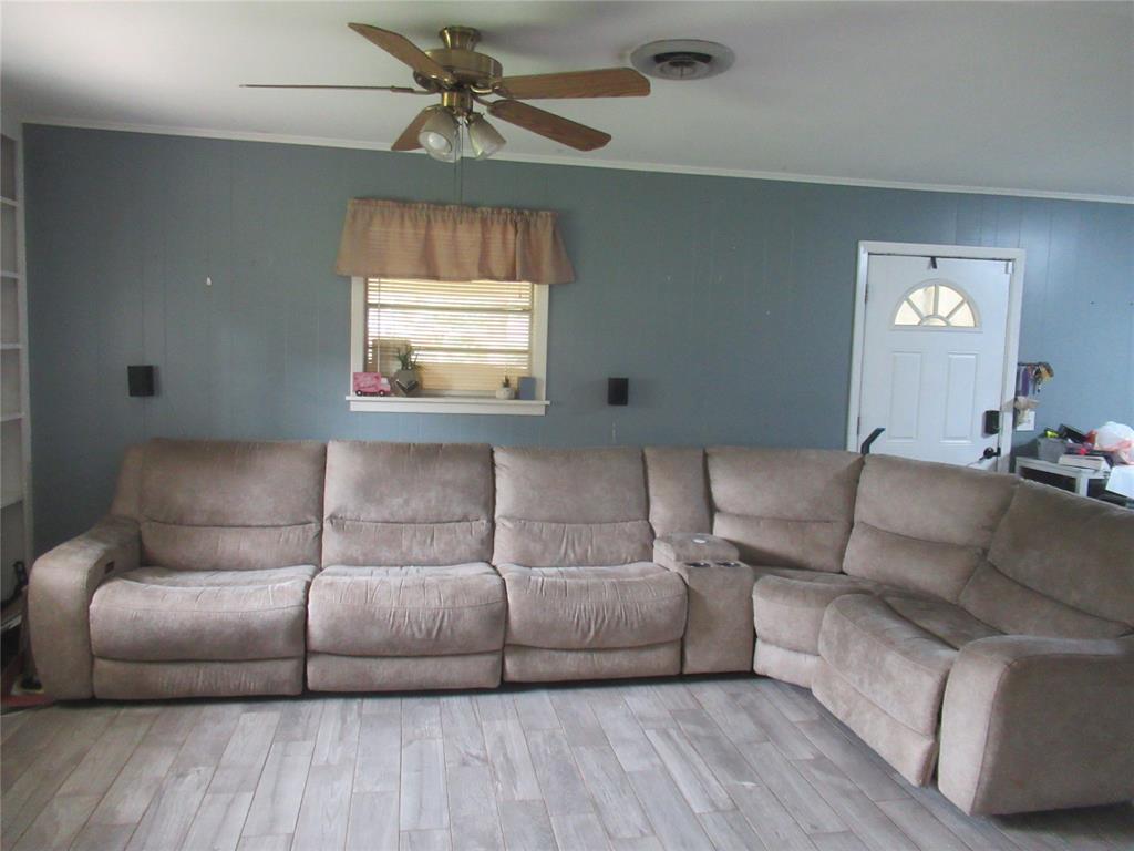 24133 Highway 157 Springhill, LA 71075 - Photo 13 of 19 Spacious room featuring wood-finish flooring, a ceiling fan with integrated lighting, and a window with blinds