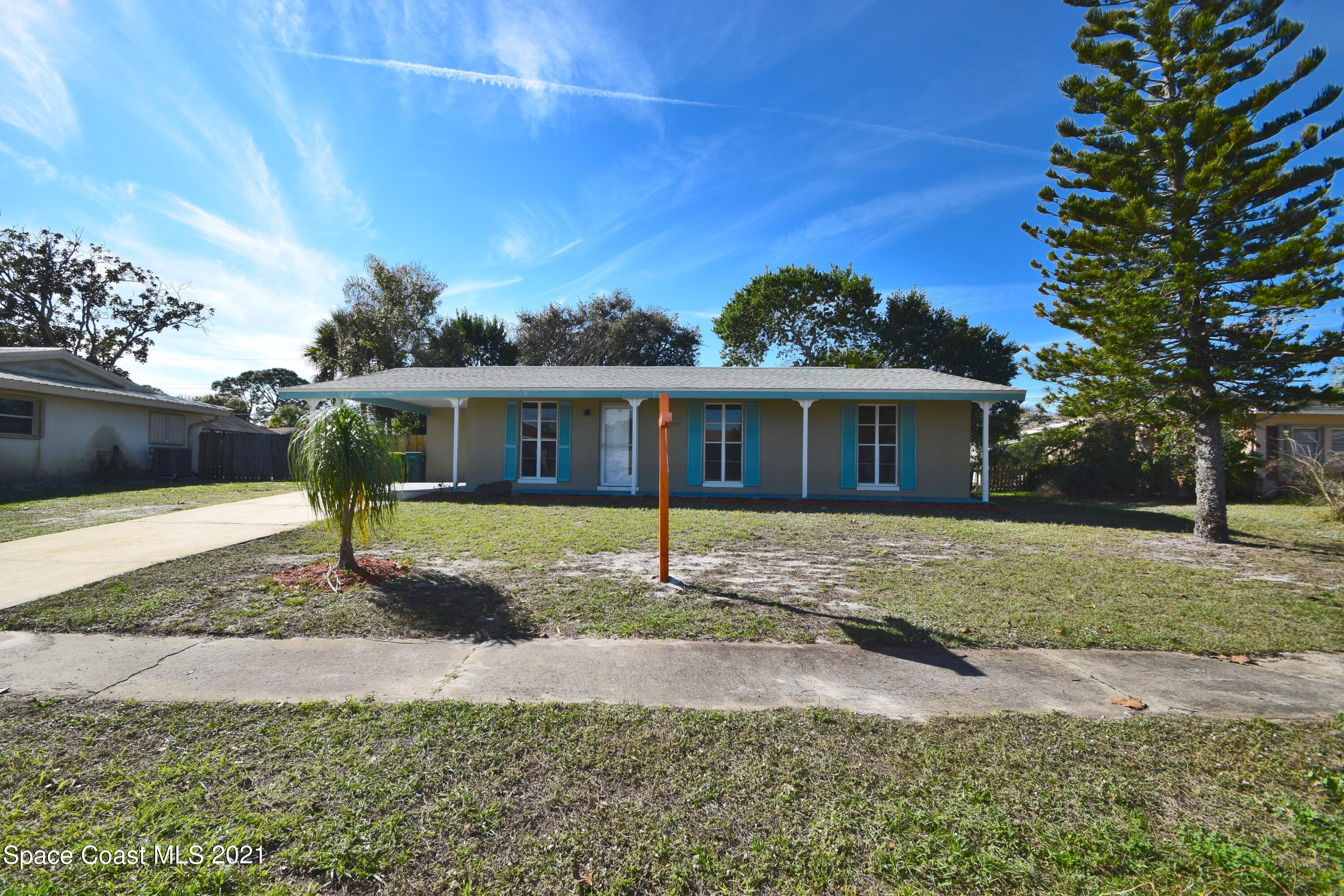 a view of a house with a yard and tree s
