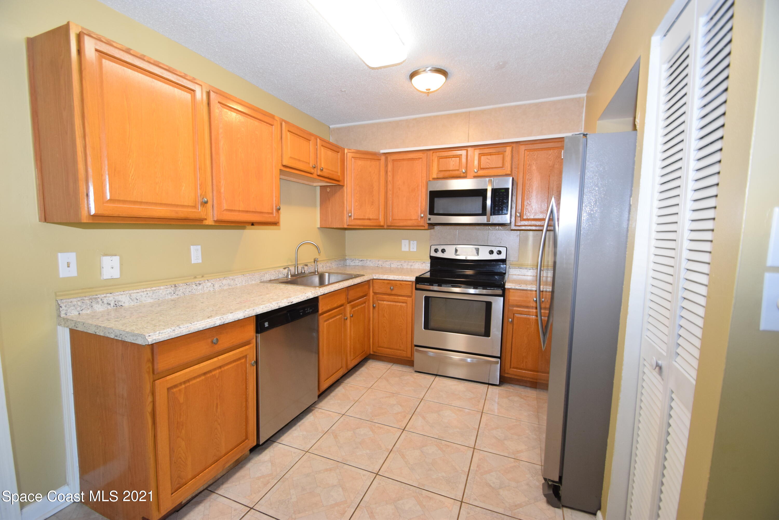 680 Aloha Avenue Cocoa, FL 32927 - Photo 12 of 27 a kitchen with a sink stove top oven and refrigerator