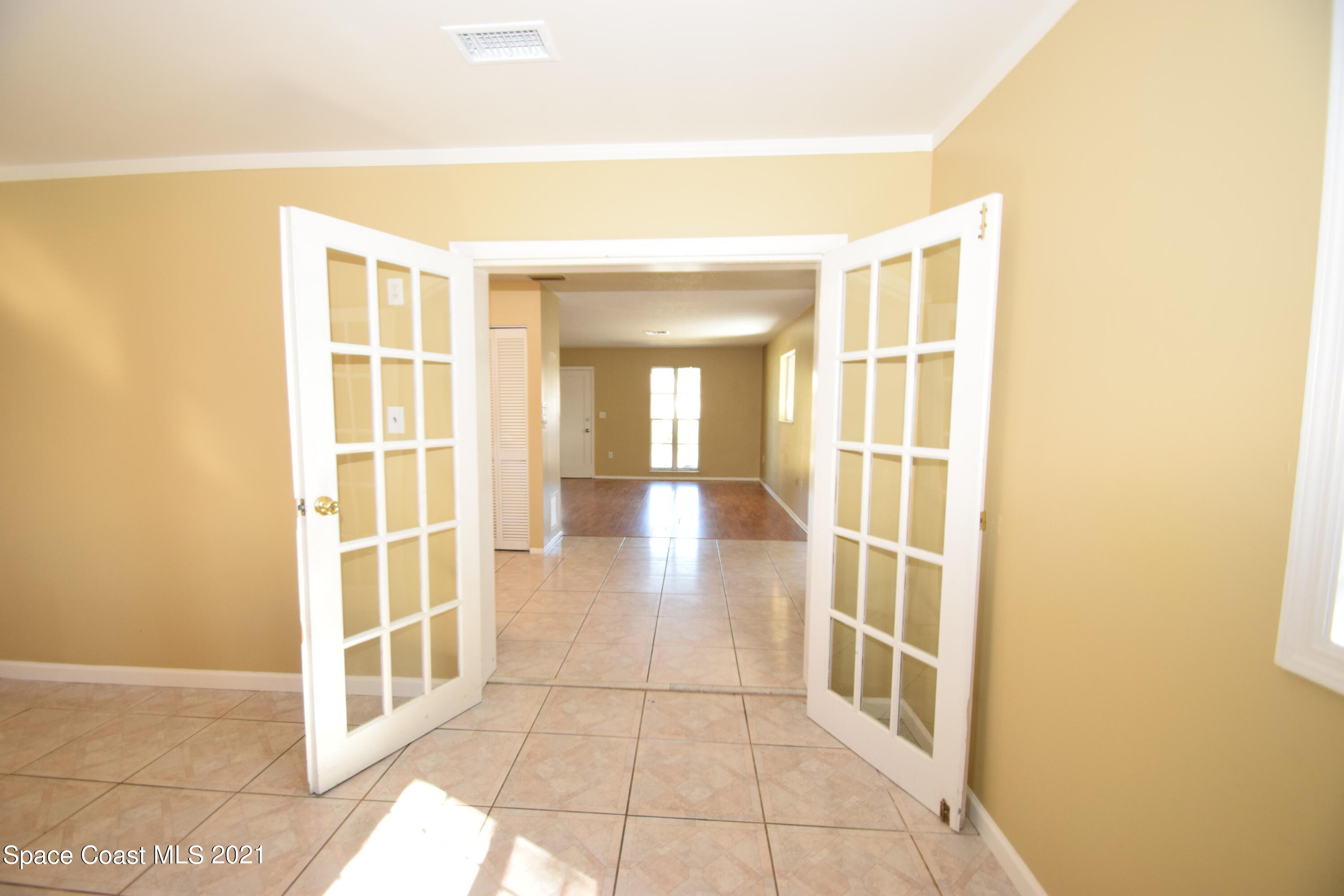 680 Aloha Avenue Cocoa, FL 32927 - Photo 15 of 27 a view of a hallway with wooden floor and a bathroom