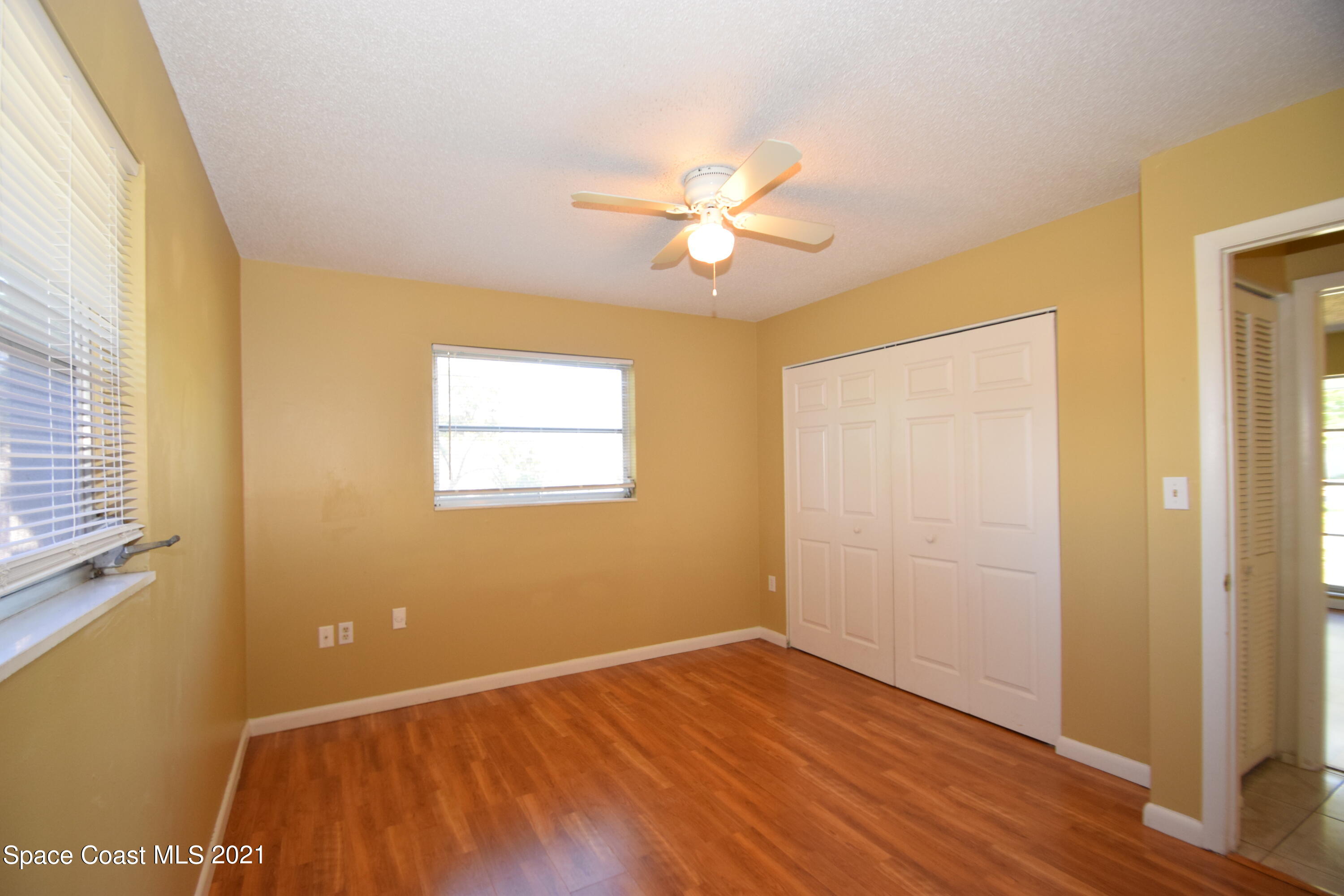 680 Aloha Avenue Cocoa, FL 32927 - Photo 22 of 27 a view of an empty room with wooden floor and a window