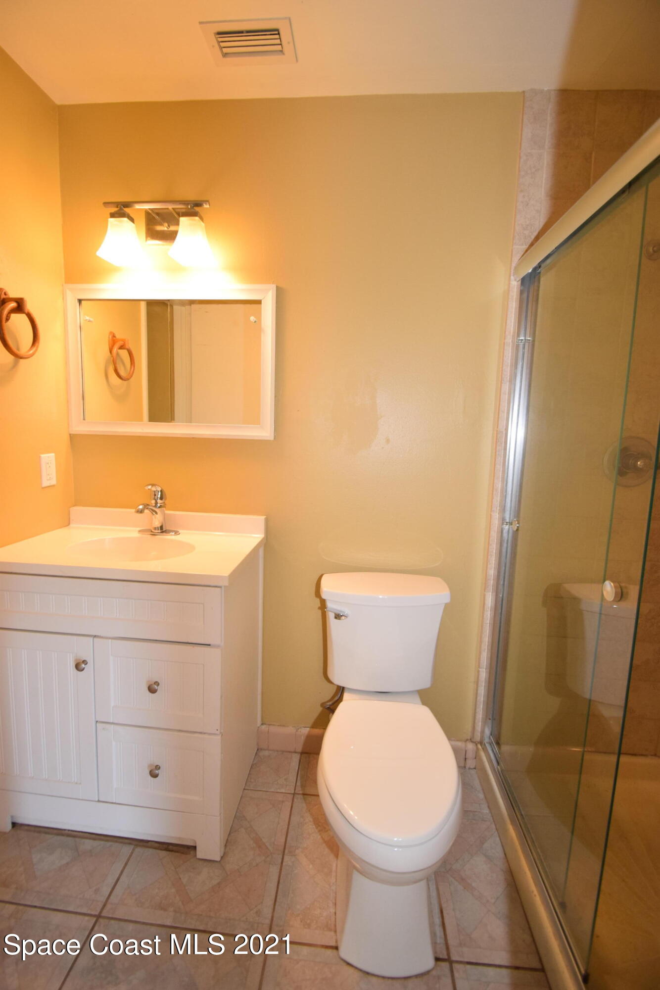 680 Aloha Avenue Cocoa, FL 32927 - Photo 25 of 27 a bathroom with a toilet sink and mirror