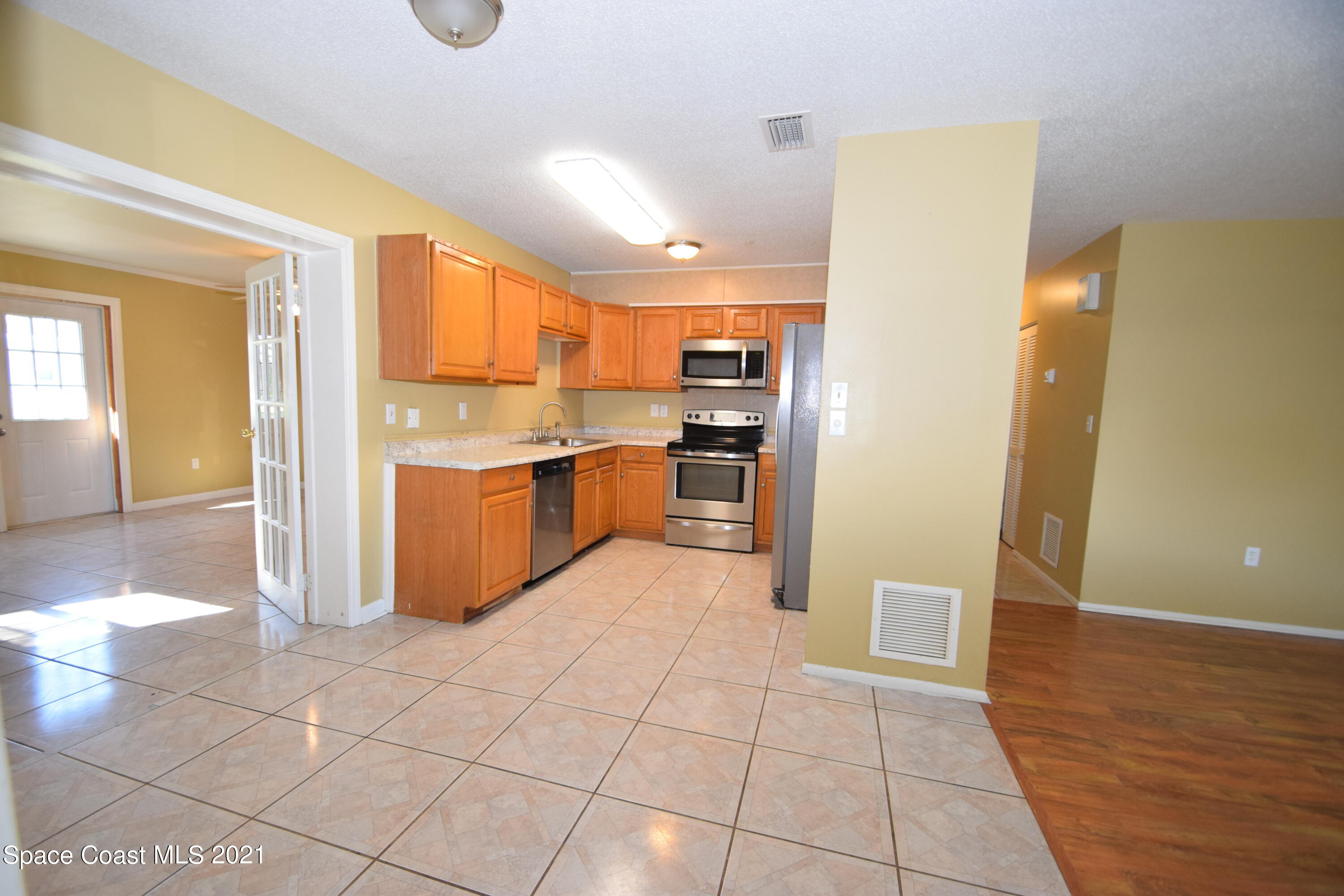 680 Aloha Avenue Cocoa, FL 32927 - Photo 9 of 27 a kitchen with stainless steel appliances granite countertop a refrigerator and a stove top oven