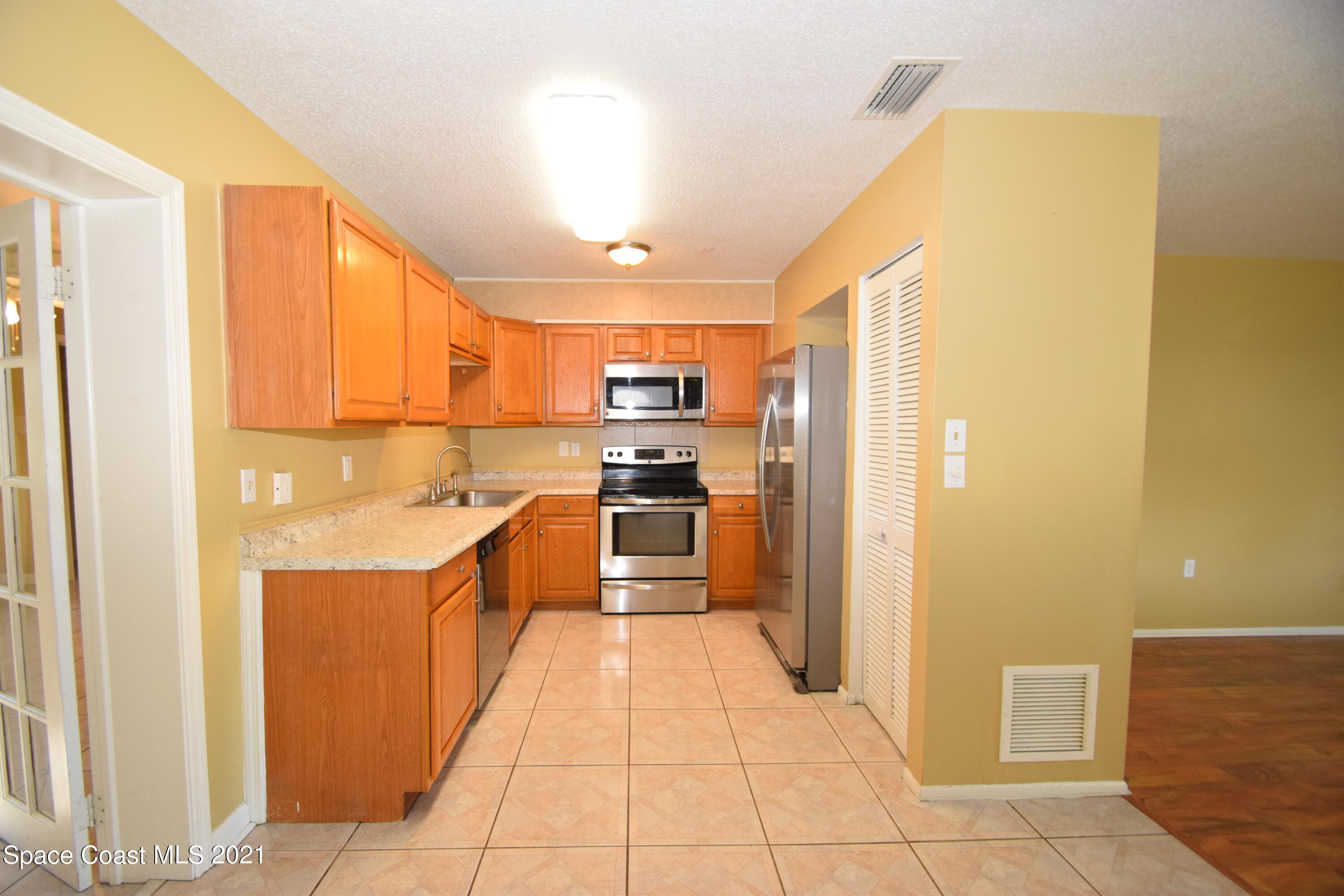 680 Aloha Avenue Cocoa, FL 32927 - Photo 10 of 27 a kitchen with stainless steel appliances granite countertop a refrigerator and a stove top oven
