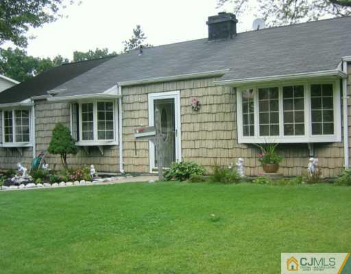 3 Kenmore Road Edison, NJ 08817 - Photo 1 of 8 a front view of a house with a garden and plants