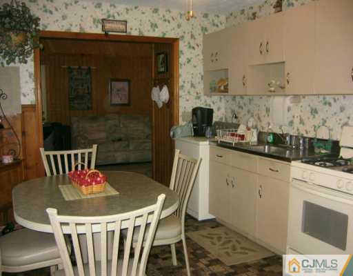 3 Kenmore Road Edison, NJ 08817 - Photo 2 of 8 a kitchen with a table and chairs