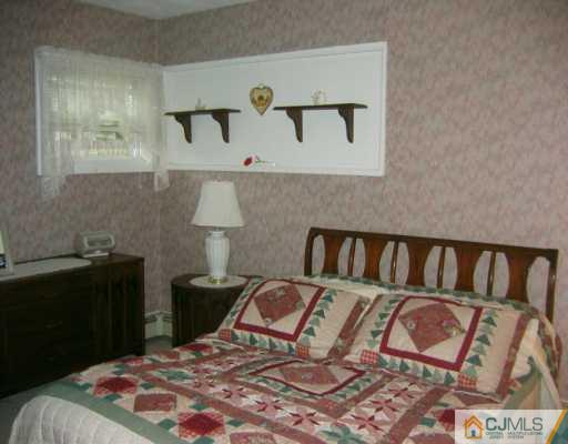 3 Kenmore Road Edison, NJ 08817 - Photo 5 of 8 a bedroom with a bed and window