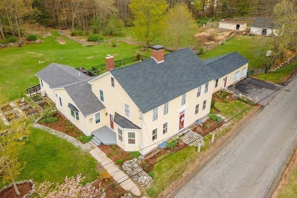 an aerial view of a house with a yard