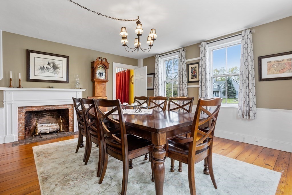85 Forest Street Dunstable, MA 01827 - Photo 12 of 42 a view of a dining room with furniture a chandelier and wooden floor
