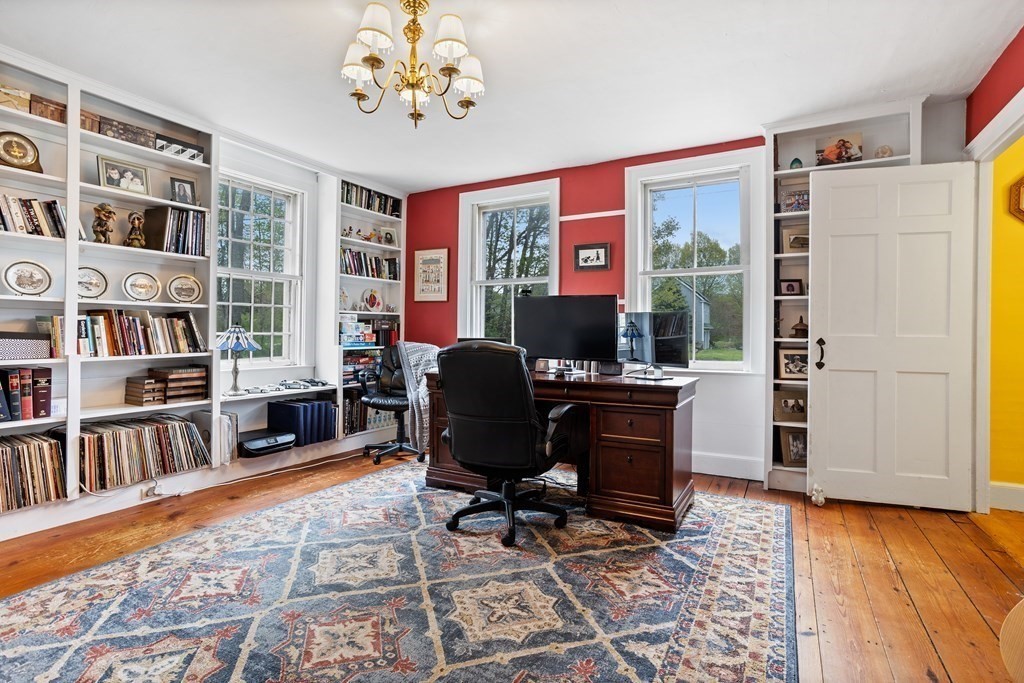 85 Forest Street Dunstable, MA 01827 - Photo 19 of 42 a view of a workspace with furniture and a book shelf