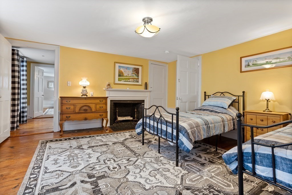 85 Forest Street Dunstable, MA 01827 - Photo 27 of 42 a bedroom with a bed and a fireplace