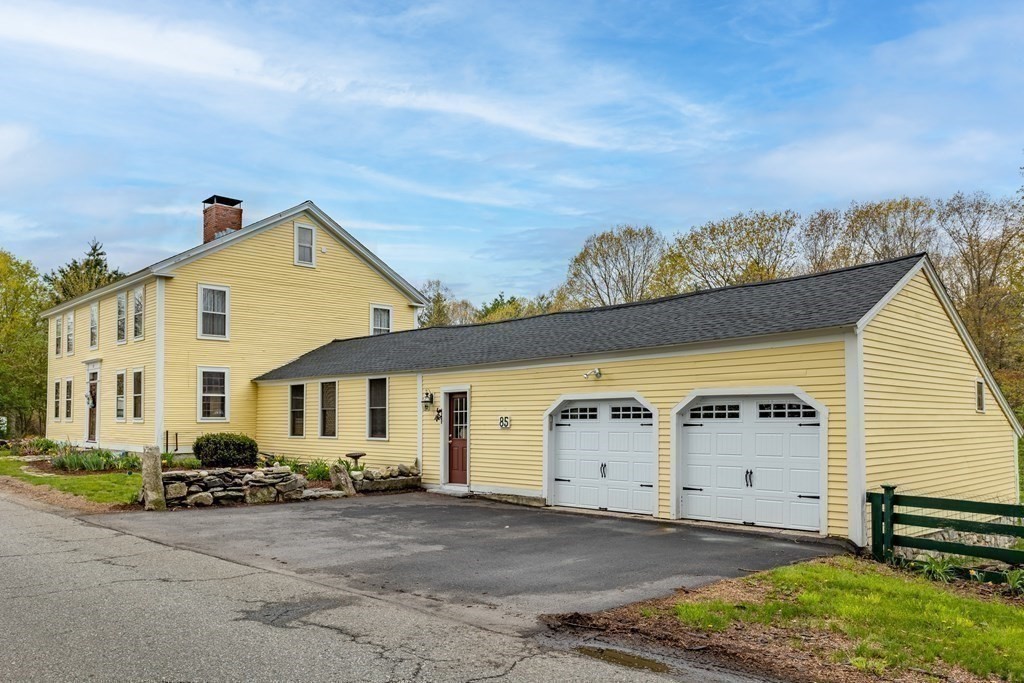85 Forest Street Dunstable, MA 01827 - Photo 3 of 42 a front view of a house with a yard and garage