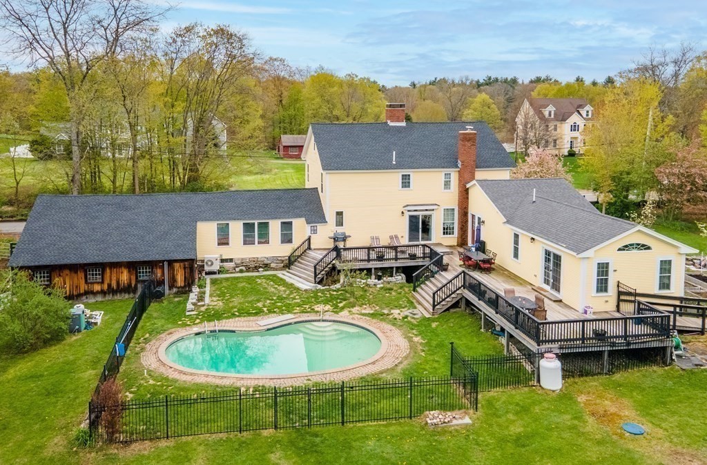 85 Forest Street Dunstable, MA 01827 - Photo 5 of 42 an aerial view of a house with swimming pool and a yard
