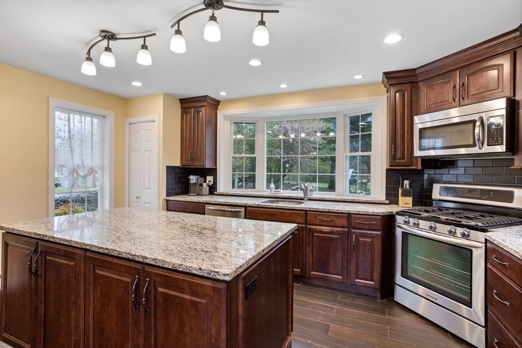 85 Forest Street Dunstable, MA 01827 - Photo 8 of 42 a kitchen with a stove sink and microwave