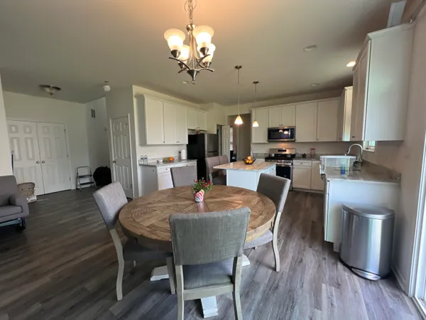 a view of a dining room with furniture and wooden floor
