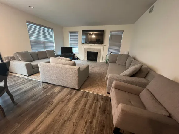a living room with furniture fireplace and flat screen tv