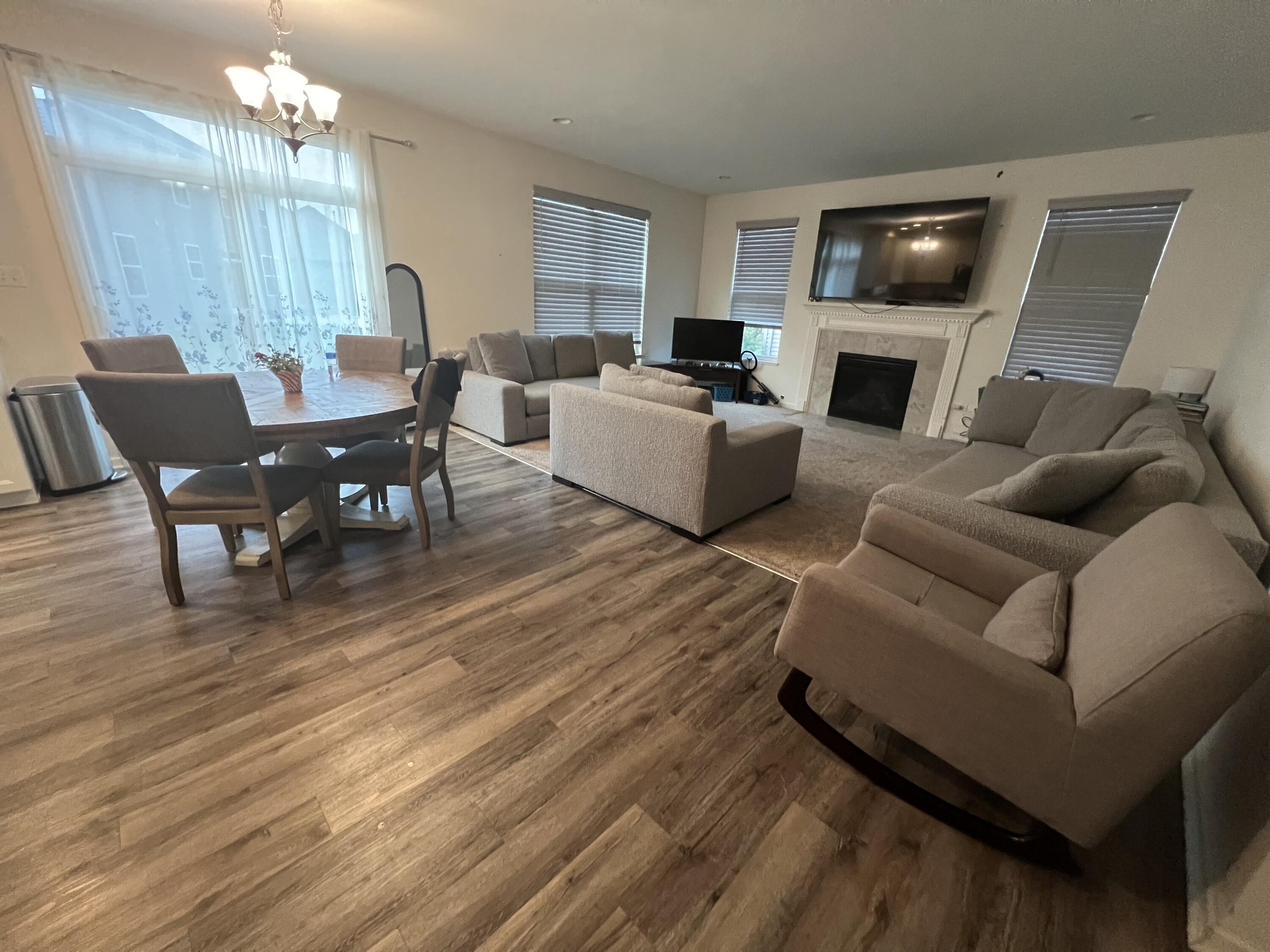 10193 California Street Crown Point, IN 46307 - Photo 12 of 33 a living room with furniture a fireplace a flat screen tv and kitchen view
