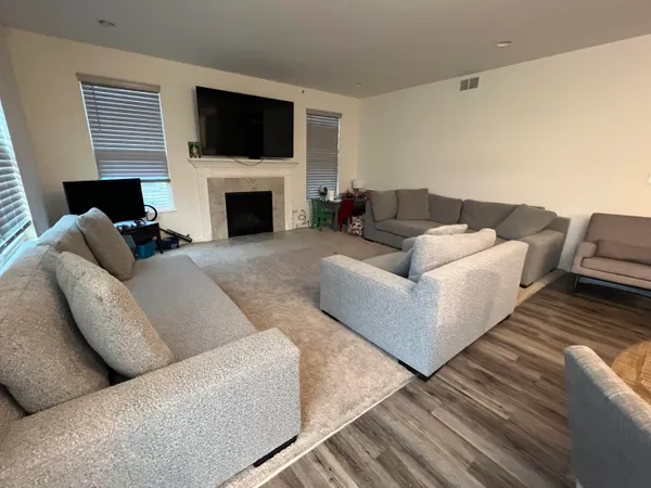 a living room with furniture flat screen tv and a fireplace