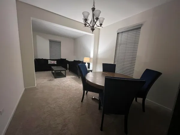a dining room with furniture and window