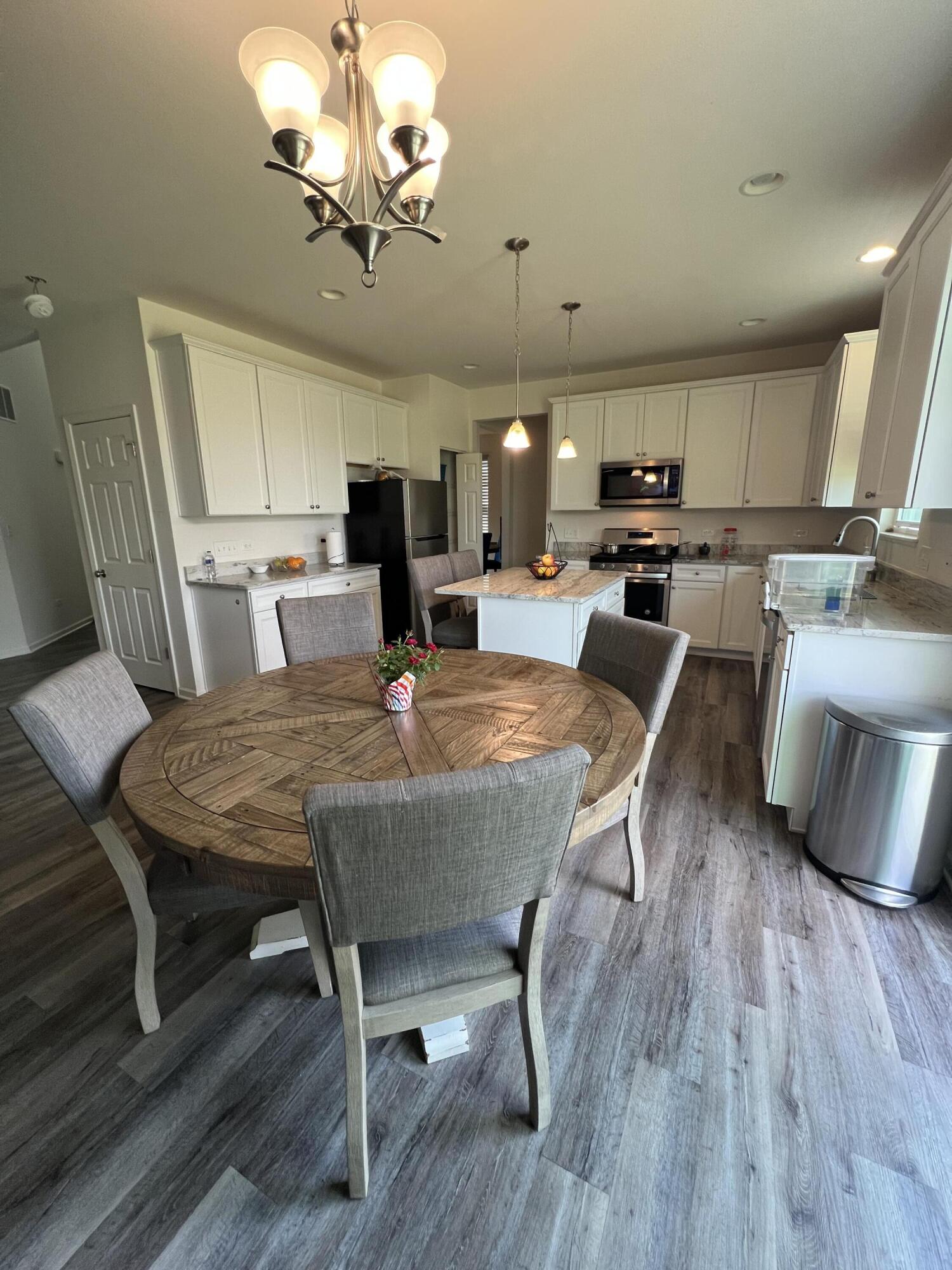 10193 California Street Crown Point, IN 46307 - Photo 2 of 33 a view of a dining room with furniture a rug and wooden floor