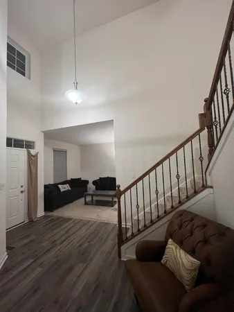 a living room with furniture and wooden floor