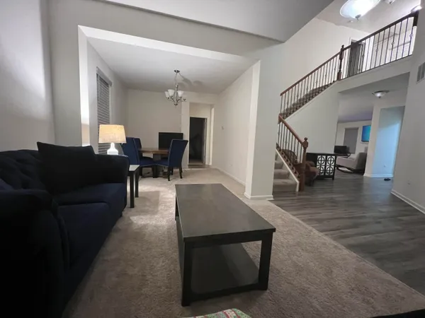 a living room with furniture and a dining table