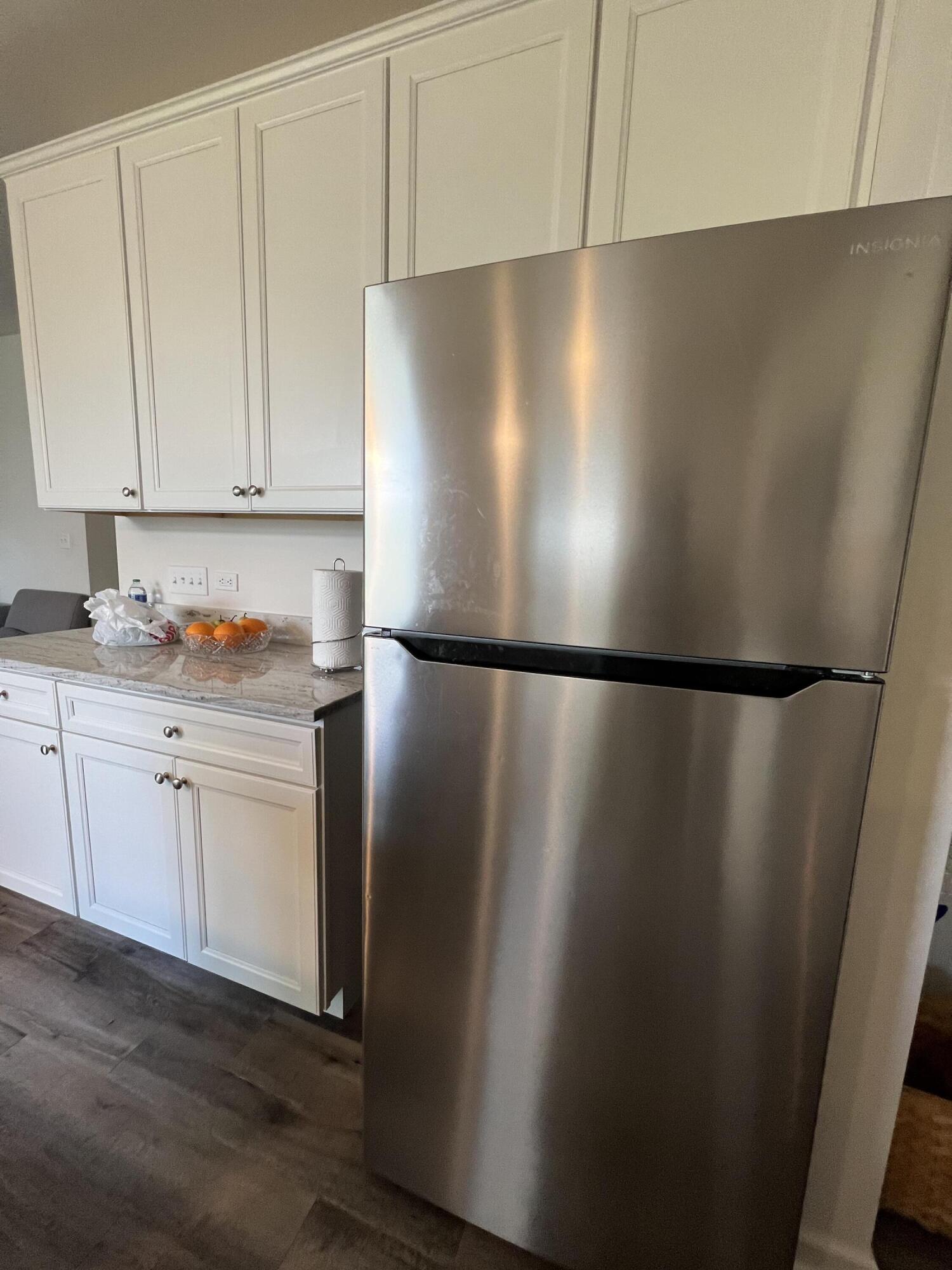 10193 California Street Crown Point, IN 46307 - Photo 26 of 33 a view of a refrigerator in kitchen and white cabinets