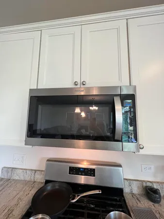 a bathroom with a sink and a microwave