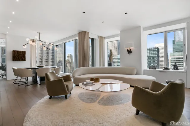 a living room with furniture and large windows
