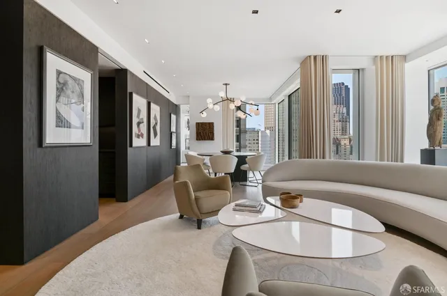 a living room with furniture and large windows