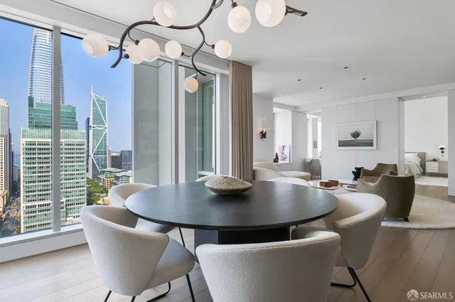 a view of livingroom and dining room with furniture wooden floor a chandelier