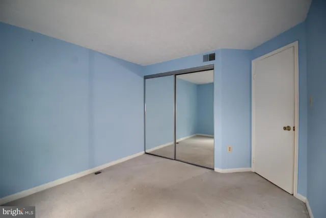 a bedroom with a bed and closet