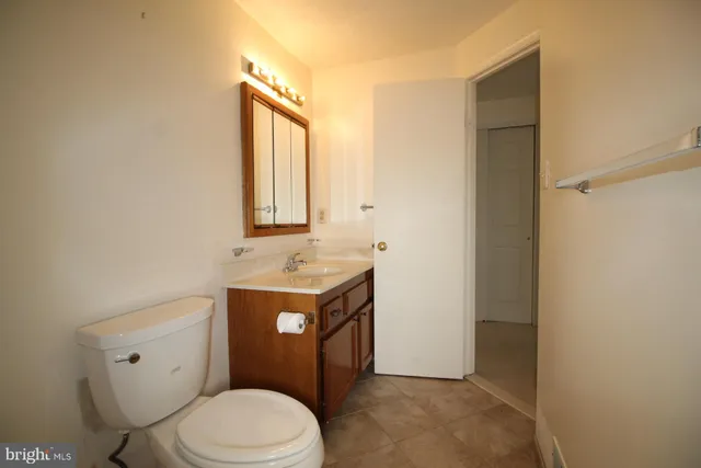 a bathroom with a toilet a sink and mirror